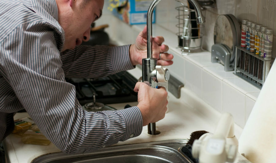 image of plumber working in the house